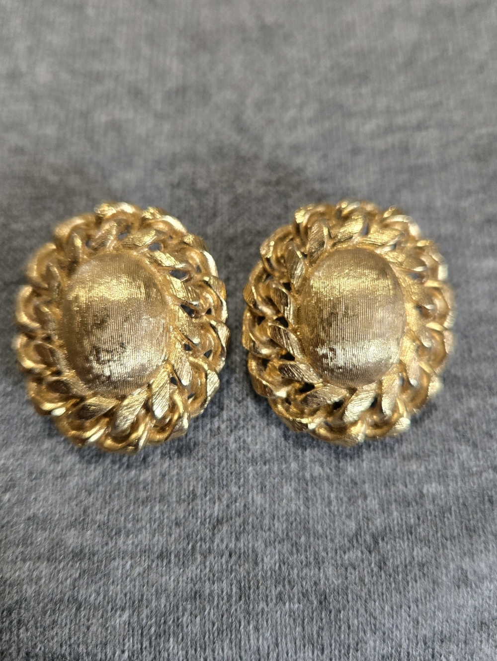 Vintage Monet Clip On Earrings Gold Tone Textured Oval Domed Center Chain Border